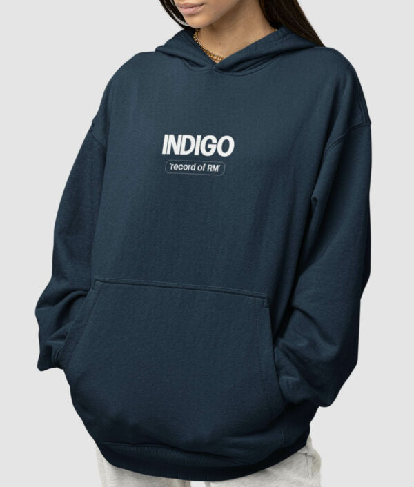 A women wearing the Indigo "Record of RM" Hoodie, showcasing the back design with the tracklist of the Indigo album