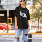 Female model wearing Karma Is My Boyfriend Oversized T-Shirt, showcasing Taylor Swift lyrics design